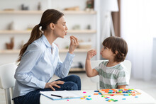 Young Woman Speech Therapist Studying Together With Small Kid, Learning Practice Pronunciation Exercises With Little Boy