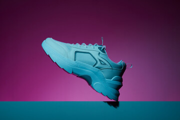 Wall Mural - Fashion white female sneakers in neon light. Violet and purple gradient. Trend color.