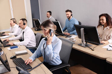 Wall Mural - Call center operators working in modern office