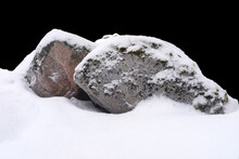 Natural Stone In Snow Isolated On Black Background