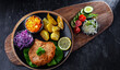 Pork cutlet coated with breadcrumbs with potatoes and salads