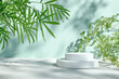 White gypsum cylinder podiums display and palm leaves on pastel light green surface for product presentation. Pedestal stand. Cosmetics or eco beauty product promotion trendy minimalist mockup