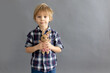 © Tomsickova - Little toddler child, blond boy, playing with handmade little knitted toy
