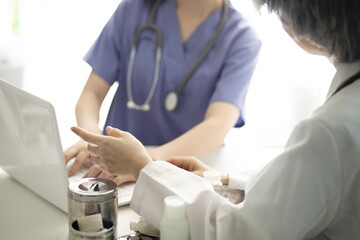 Doctors using laptop in meeting