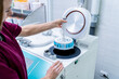 © romaset - Laboratory assistant works with microwave hybrid tissue processor at the modern laboratory.