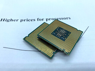 Two microprocessors on a paper written higher prices closeup view