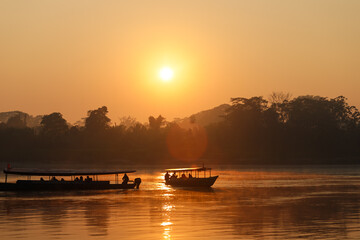 Beautiful red and orange sunrise at Rio Madre de Dios near Puerto Maldonado in the Tambopata National Park in the Amazonas region (Peru, South America)