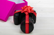 DSLR Camera with a zoom lens gift-wrapped with red ribbon bow