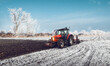 © Dusan Kostic - Tractor plowing a field in winter
