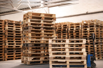 Wall Mural - Modern manual forklift and wooden pallets in warehouse