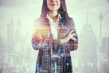 Poster - Attractive young european businesswoman with folded arms standing on bright city background with candlestick forex grid chart. Trade, finance and economy concept. Double exposure.