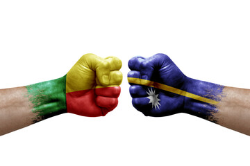 Two hands punch to each others on white background. Country flags painted fists, conflict crisis concept between benin and nauru