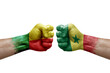 Two hands punch to each others on white background. Country flags painted fists, conflict crisis concept between benin and senegal