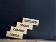 Inspirational and Motivational Concept - DECIDE COMMIT FOCUS SUCCEED text background. Stock photo.