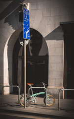 Sticker - A vertical shot of a green bicycle standing at the parking.