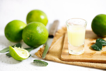 Wall Mural - Lime juice and fresh green limes.