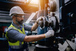 © sirichai - A senior mechanical engineer in a safety uniform wearing glasses is checking the operation of the machines in the factory.