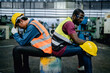 © sirichai - Factory workers or Mechanics feel tired from hard work in a factory, weak, hopeless, burned out, Fired Unemployed Feeling Stressed.