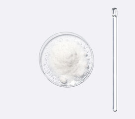 Closeup chemical ingredient on white laboratory table. Di-Ammonium Prosphate in Chemical Watch Glass placed next to stirring rod. Top View