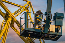 Assemblers Repairing A Harbor Crane On A High Lift