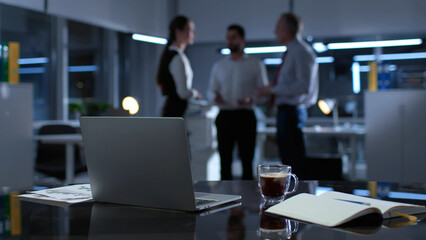 Blurred shot of business colleague talking late in office