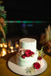 © Alexander - night wedding ceremony, the arch is decorated with flowers, candles and garlands of light bulbs and there is a wedding cake on the table