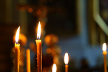 Candles In A Christian Orthodox Church Background. Flame Of Candles In The Dark Sacred Interior Of The Temple