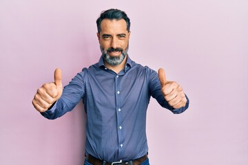 Sticker - Middle age man with beard and grey hair wearing business clothes approving doing positive gesture with hand, thumbs up smiling and happy for success. winner gesture.