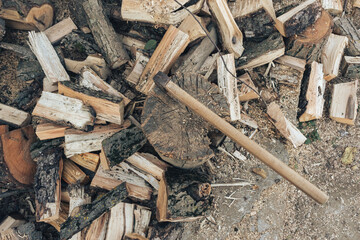 The ax lies on the wood. Firewood chopping. Preparation of firewood for the winter. Iron ax with wooden handle