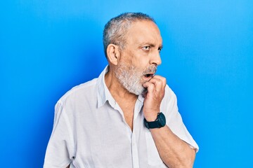 Sticker - Handsome senior man with beard wearing casual white shirt looking stressed and nervous with hands on mouth biting nails. anxiety problem.