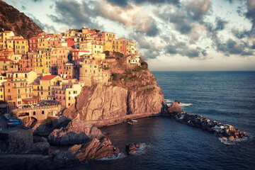 Wall Mural - Manarola village on cliff rocks and sea at sunset., Seascape in Five lands, Cinque Terre National Park, Liguria Italy Europe