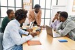 © Krakenimages.com - Group of young african american business workers smiling happy working at the office.