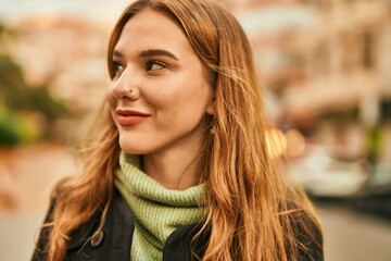 Canvas Print - Young blonde girl smiling happy standing at the city.