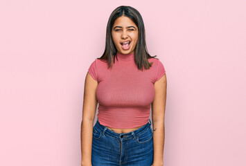 Poster - Young hispanic girl wearing casual t shirt winking looking at the camera with sexy expression, cheerful and happy face.