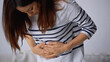 © LIGHTFIELD STUDIOS - woman touching belly while suffering from abdominal pain