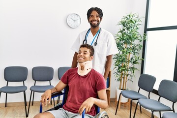 Sticker - Two men physiptherapist and patient sitting on wheelchair having medical consultation at hospital waiting room