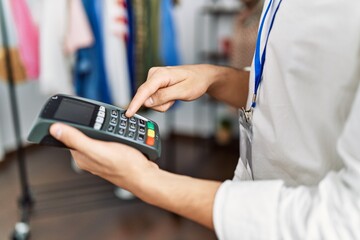 Sticker - Young arab man smiling confident using data phone device at clothing store