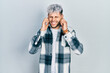 © Krakenimages.com - Young hispanic man with modern dyed hair wearing casual shirt covering ears with fingers with annoyed expression for the noise of loud music. deaf concept.