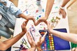 © Krakenimages.com - Group of people doing heart sign with hands together at art studio.