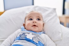 Adorable Baby Relaxed Lying On Bed At Bedroom