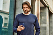 © Krakenimages.com - Middle age handsome man using smartphone at the town
