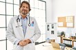 © Krakenimages.com - Middle age caucasian man wearing doctor uniform standing with arms crossed gesture al clinic