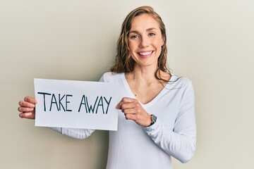 Poster - Young blonde woman holding take away food smiling with a happy and cool smile on face. showing teeth.