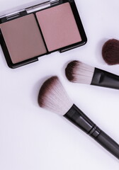 Wall Mural - Minimal style,face blush and makeup brushes on white background, flat lay, top view.