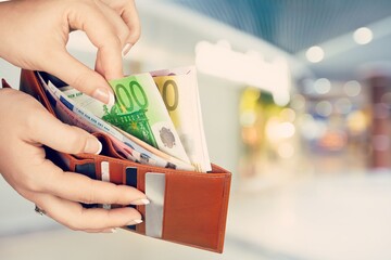 Wall Mural - Hand taking out money from pocket wallet. Counting money, economy concept, money distribution