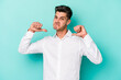 © Asier - Young caucasian man isolated on blue background feels proud and self confident, example to follow.