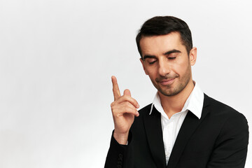 successful manwith closed eyes shows index finger up emotion self-confidence official isolated background