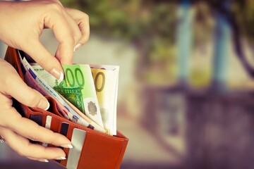 Wall Mural - Hand taking out money from pocket wallet. Counting money, economy concept, money distribution