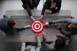 © alotofpeople - Business people pointing at red target