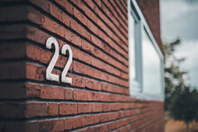 House Number Sign On A Brick Wall